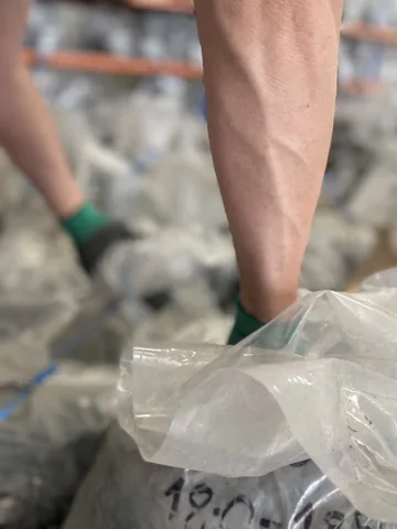 A close view of material being handled in a sample bag.