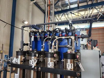 A wide view of the pilot treatment system with blue vessels, pipework and controls.