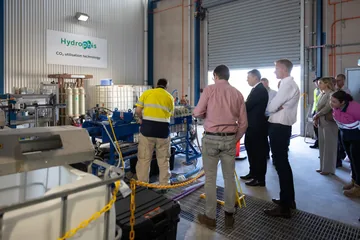 A group of visitors being shown around the Adelaide pilot equipment.