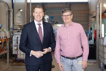 Two visitors pictured together inside the Adelaide pilot facility.