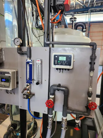A pilot control panel with a digital display, flow meters and connecting hoses.