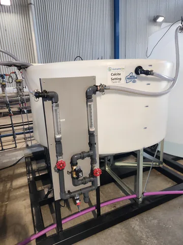 White pilot tanks with connecting pipework and valves.