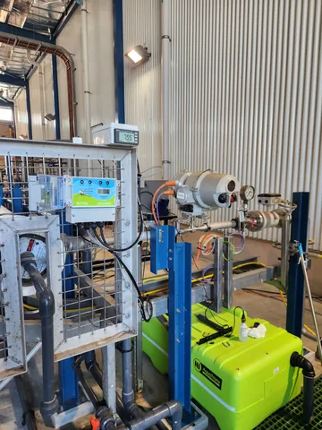 A view of pilot equipment, blue hoses and containers inside the Adelaide facility.